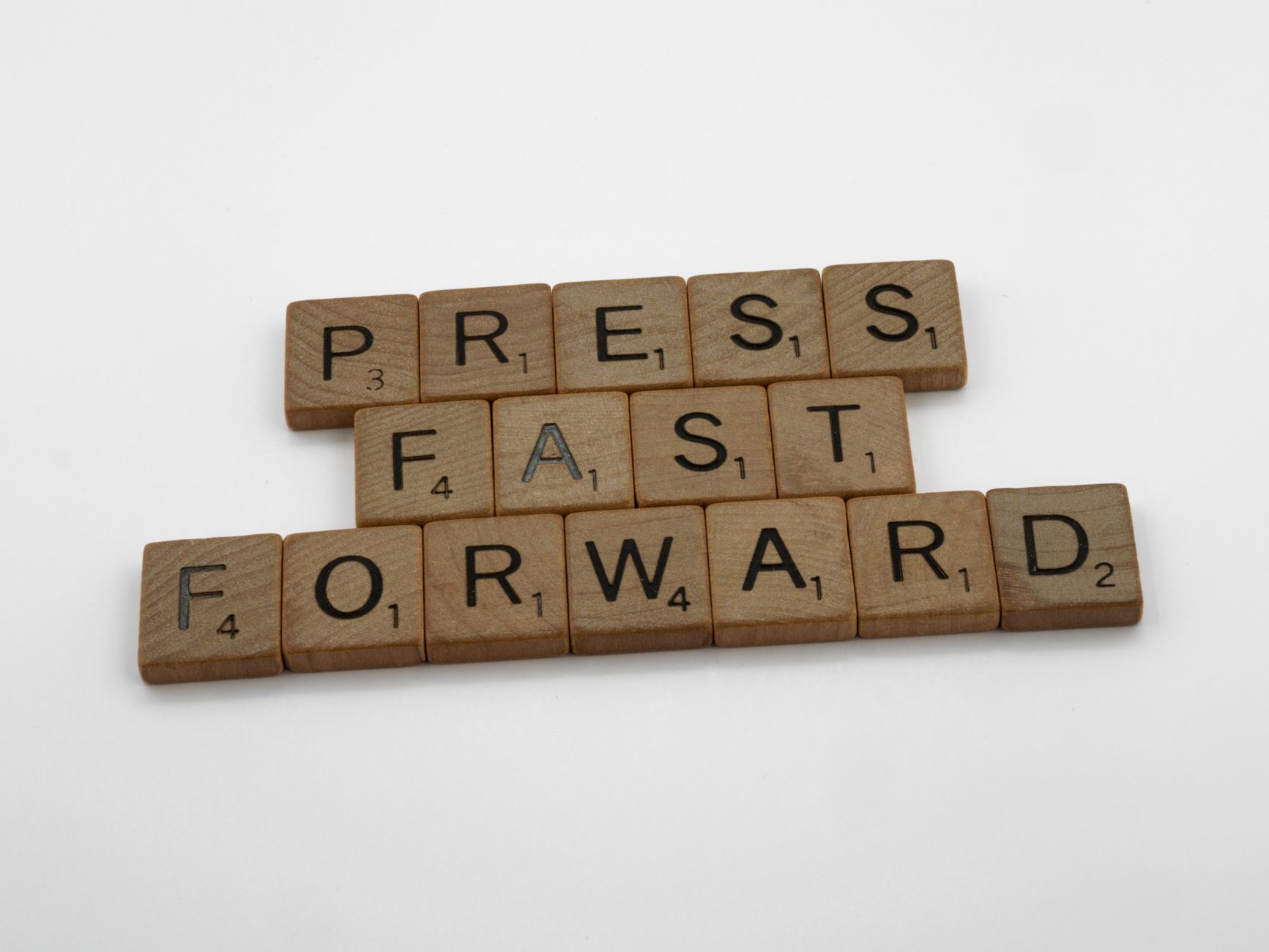 press fast forward spelled on scrabble pieces